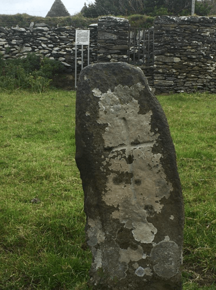 St Brendan’s cross slab and holy well with Kilmalkedar church in the background. Holy wells pre-dates Christianity.