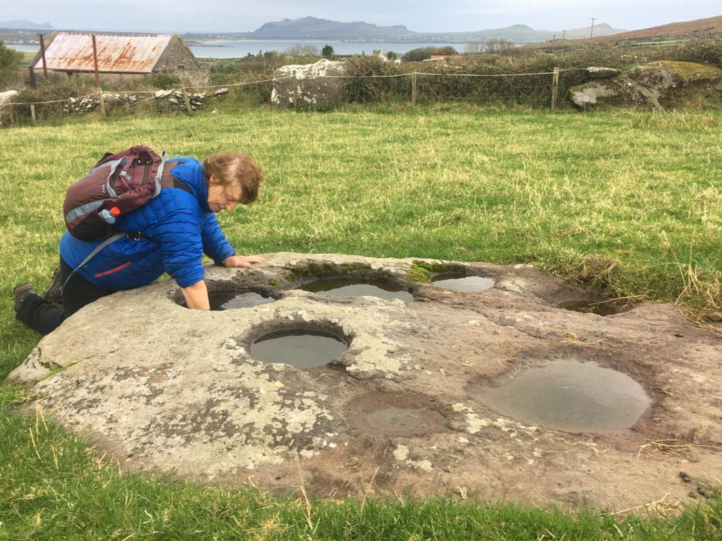 Families knelt around this rock each member using a round stone to grind grain in these stone basins. This bullaun stone may date as far back as the 5th century